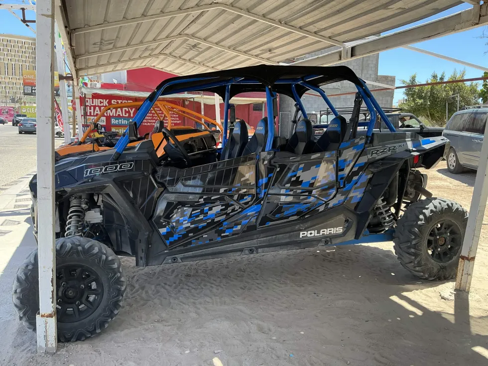 Side view of a blue Polaris RZR side-by-side