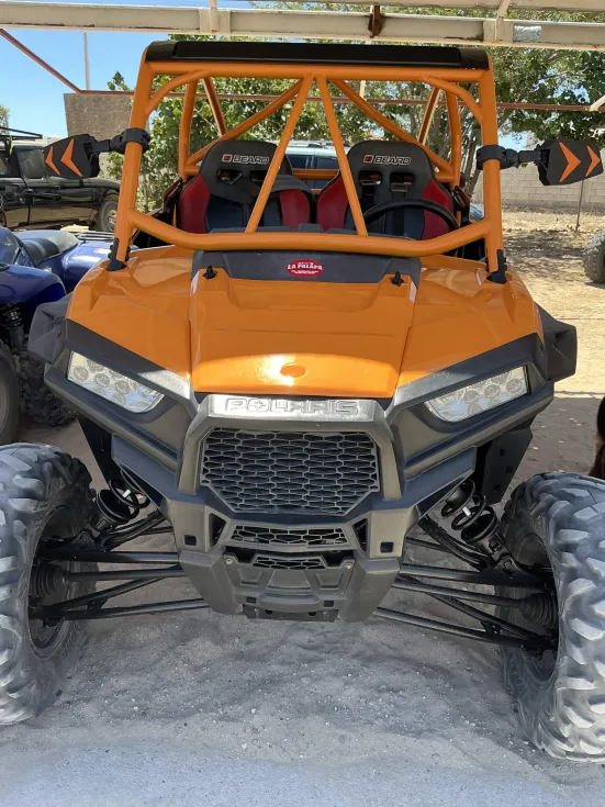 Orange 4-seat Polaris RZR side-by-side from the La Palapa fleet